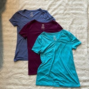 V neck shirts bluish/purple, purple, and teal. Size small and xs
